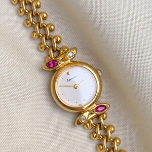 Reloj vintage Dana By Orient para mujer con rubíes y diamantes.