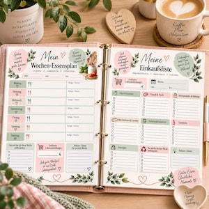 May include: A ring-bound planner open to two pages featuring a weekly meal plan on the left and a grocery shopping list on the right. The pages are decorated with soft pink and green accents, botanical illustrations, and German text headings.