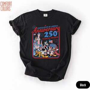 May include: Black t-shirt featuring a colorful graphic celebrating the 250th anniversary of the United States of America. The design includes Disney characters, fireworks, and the text "Anniversary 250 Years of Freedom."
