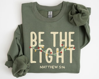 Felpa "Be The Light", felpa natalizia religiosa, maglione per le feste cristiane, regalo basato sulla fede, regalo di Natale, abbigliamento festivo
