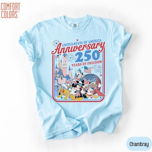 May include: Light blue t-shirt with a graphic celebrating the United States of America's 250th Anniversary. The design features Disney characters, fireworks, and the text "United State of America Anniversary 250 Years of Freedom."