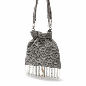 May include: A gray beaded drawstring bag with a scalloped pattern and beaded fringe. The bag has a matching beaded strap and is suspended against a white background. The bag's design is reminiscent of vintage styles.
