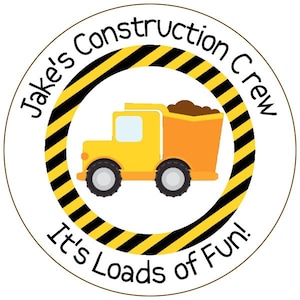 May include: A yellow construction truck with a brown load in the bed. The truck is inside a black and yellow striped circle with the text "Jake's Construction Crew It's Loads of Fun!"
