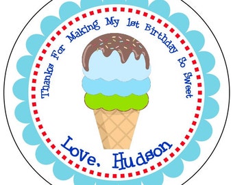 May include: Round blue and white favour sticker with a red dotted border. The sticker features a cartoon ice cream cone with chocolate, blue and green ice cream and sprinkles. The text on the sticker reads "Thanks for making my 1st birthday so sweet. Love, Hudson."