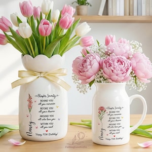 May include: A white ceramic vase and a white ceramic mug, both featuring the text 'Chapter Seventy', 'BEHIND YOU all your memories', 'BEFORE YOU all your dreams', 'AROUND YOU all who love you', 'WITHIN YOU all you need', 'Nancy', and 'Happy 70th Birthday'.