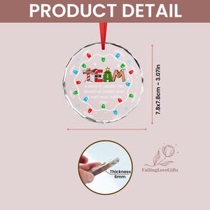 May include: A round, clear glass Christmas ornament with a red ribbon hanger. The design features the word TEAM, a holiday graphic, and the text A GROUP OF LEGENDS THAT SHOWED UP SHOWED HEART & MADE MAGIC HAPPEN -2026-. It measures 3.07 inches.