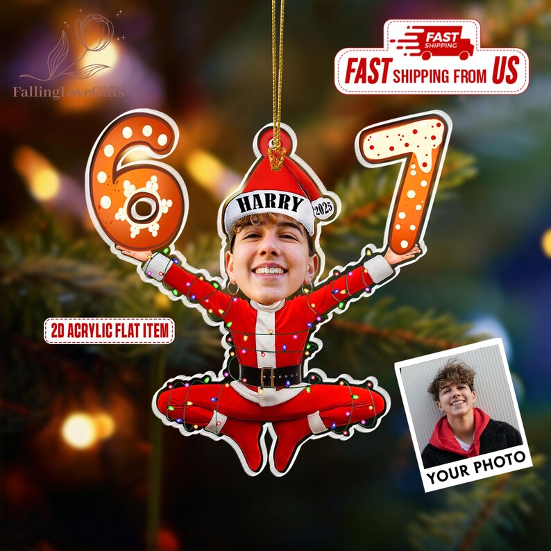 May include: A personalized Christmas ornament featuring a person's face in a Santa Claus outfit, holding the numbers "6" and "7". The ornament is red and white with a gold string for hanging. The text "HARRY 2025" is on the Santa hat.