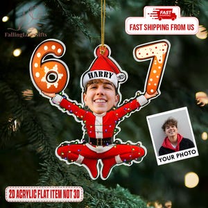 May include: A personalized Christmas ornament featuring a photo of a person in a Santa Claus outfit, holding the numbers 6 and 7. The ornament has the name "Harry" on the hat and the year "2025". The ornament is a 2D acrylic flat item.