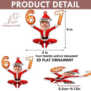May include: A flat printed acrylic ornament featuring a person's face in a Santa Claus outfit holding the numbers 6 and 7. The ornament is 4 inches wide and 4 inches tall.