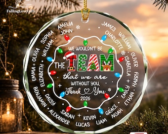 May include: A round, clear glass Christmas ornament featuring a string of colorful lights around the border. The text reads: WE WOULDN'T BE THE TEAM THAT WE ARE WITHOUT YOU, THANK YOU 2026. Names are printed in a circle around the text.