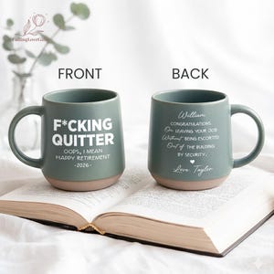 May include: Two sage green ceramic mugs with speckled textures and tan bases. The front mug displays white text reading F*CKING QUITTER OOPS, I MEAN HAPPY RETIREMENT -2026-. The back mug features white text reading William CONGRATULATIONS ON LEAVING YOUR JOB Without BEING ESCORTED Out of THE BUILDING BY SECURITY. Love, Taylor.