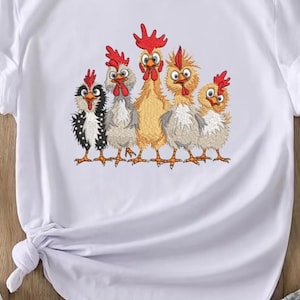 A white t-shirt with a colorful embroidered design of five cartoon chickens in various poses and colors.