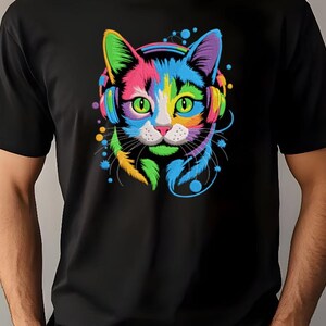 A person wearing a black t-shirt with a colorful, vibrant graphic of a cat's face and ears, along with a pair of headphones.