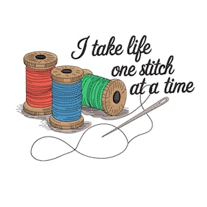 May include: An illustration features three spools of thread in red, blue, and green, with a needle and thread. The text "I take life one stitch at a time" is written in cursive. The spools have a wood-like appearance.