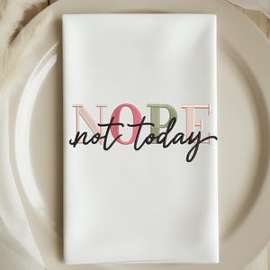 May include: A white ceramic mug with a black handle and the text "But First, Coffee" in a handwritten style. The mug is on a white surface. The mug is approximately 4 inches tall.