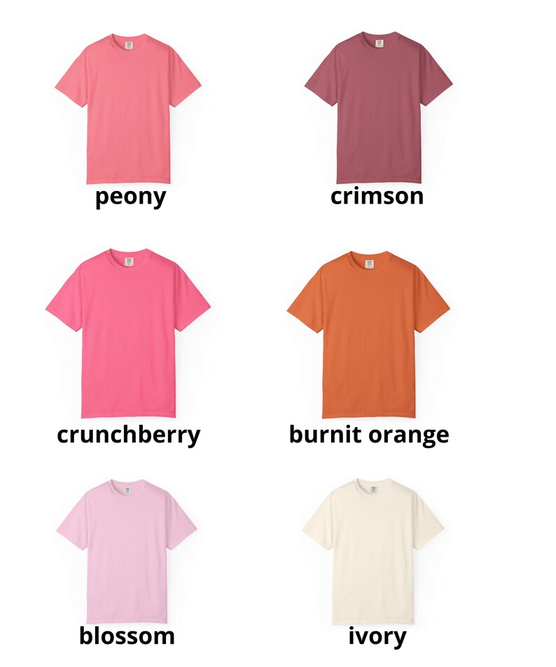 May include: A collection of six short-sleeved t-shirts in various colors: peony, crimson, crunchberry, burnt orange, blossom, and ivory. Each shirt has a crew neck and is displayed on a white background.