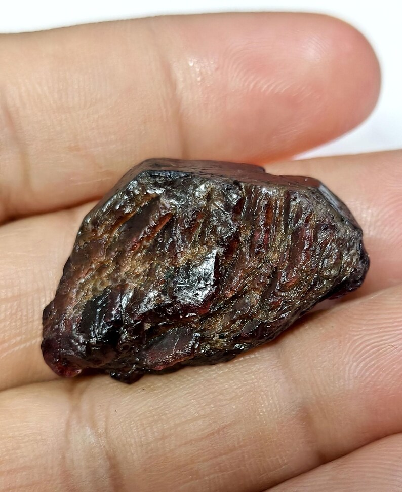 May include: A white ceramic mug with a black handle and the text "But First, Coffee" in a bold, black font. The mug is set against a blurred background, suggesting a cozy setting.