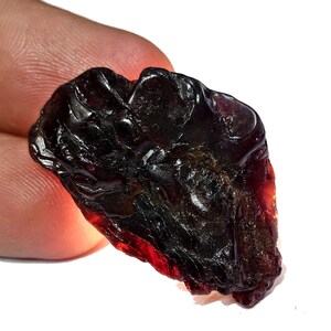 May include: A white ceramic mug with a black handle and the text "But First, Coffee" in a bold, black font. The mug is sitting on a wooden surface. The mug is approximately 4 inches tall.