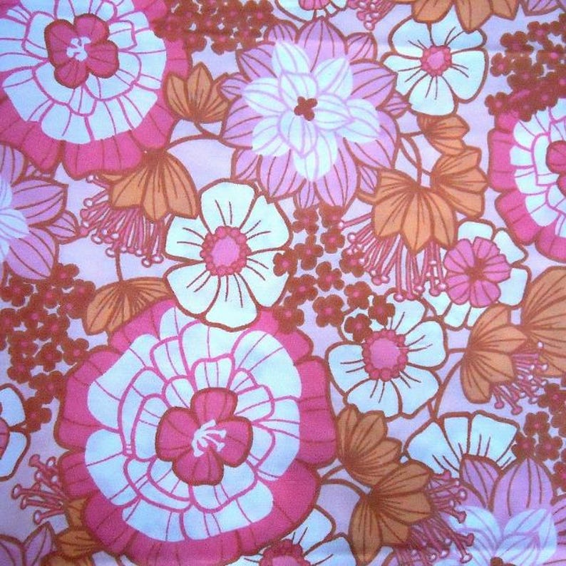May include: A pink and white floral fabric with a retro 70s design. The fabric features large and small flowers in shades of pink, white, and orange.