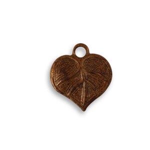May include: A bronze-colored leaf-shaped pendant with a textured surface and a small loop at the top for hanging. The pendant is a heart shape with detailed veining, ideal for jewelry making or crafting.