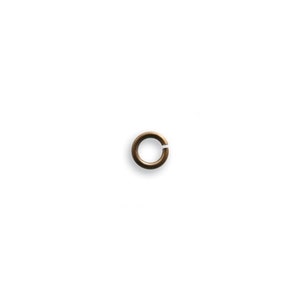 May include: A single, open jump ring in a bronze color, set against a white background. The ring is circular with a small gap, suggesting it is designed for jewelry making or crafting. The bronze finish gives it a vintage or antique appearance.