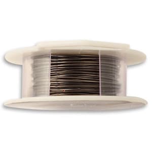 May include: A spool of black wire in a clear plastic container. The wire is wound tightly around the spool.