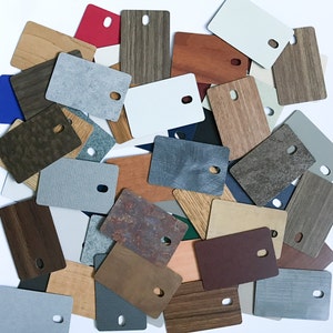 May include: A collection of various colored and textured sheets of material. The sheets are arranged in a random pattern and are all different sizes.