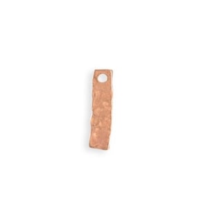 May include: A small, hammered, copper charm in the shape of a rectangle with a hole at the top.