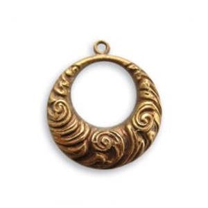 May include: A gold-toned metal pendant with a circular design featuring intricate swirling patterns. The pendant has a large open circle in the center.