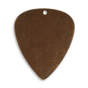 May include: A blank, brown, metal guitar pick with a hole in the top.
