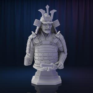 May include: A white bust sculpture of a samurai warrior wearing a helmet with a menacing expression. The samurai is wearing traditional armor with intricate details.