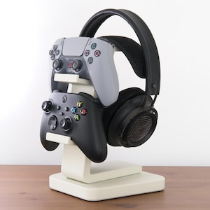 May include: A set of three ceramic mugs with a speckled, matte finish. The mugs are in shades of cream, light grey, and dark grey. Each mug has a simple, minimalist design, ideal for coffee or tea.