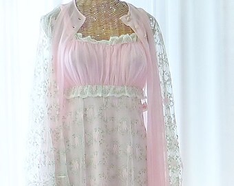 May include: A pink and white floral lace nightgown with a matching robe. The gown has a sweetheart neckline and a ruffled hem. The robe has long sleeves and a lace trim.
