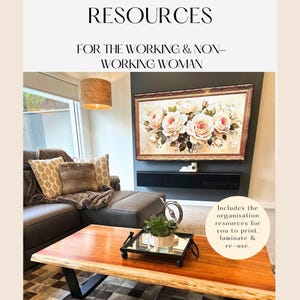 Op de afbeelding: Woonkamer met een houten salontafel, een grijze hoekbank en een groot ingelijst bloemenschilderij. De tekst op de afbeelding luidt: "THE HOUSEWIFE HACK ORGANISATION RESOURCES" en "FOR THE WORKING & NON-WORKING WOMAN".