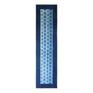 May include: A rectangular indigo blue table runner with a white and blue honeycomb pattern in the center. The runner has a dark blue border. The design is symmetrical and the background is white.