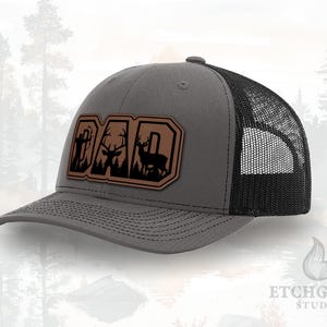 DAD Bow Hunting Hat – Deer Scene Inside Letters Patch – Leatherette Trucker Hat