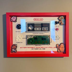 NES Controller Diorama – 40-Year Anniversary Retro Wall Art in Red A4 Shadowbox Frame. Framed Nintendo Entertainment system controller