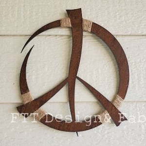 May include: A rusty metal peace sign with a brown twine wrapped around the edges. The peace sign is a popular symbol of peace and love.