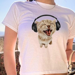 Retro Cat Headphones Baby Tee, 90s Y2K Aesthetic Cropped Shirt, Funny Vintage Cat Meme Top, Trendy Graphic Tee for Music Lovers & Gen Z