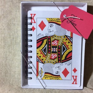 5 x 7 playing card notebooks come boxed with a clear lid and to/from tag on a stretch cord.  the 8 x 11 playing card notebooks come in a clear cellophane sleeve with to/from tag.