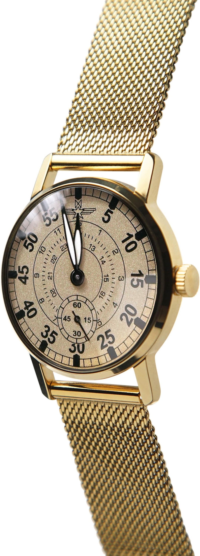 May include: Gold-toned wristwatch with a mesh band. The watch face is beige with black numerals and hands. A smaller dial is at the bottom. The watch has a gold-colored case and a mesh band.