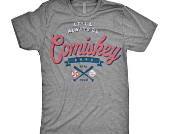 May include: Gray t-shirt with a red and blue graphic that says "It'll Always Be Comiskey Park 1910-1990". The graphic also includes two crossed baseball bats and a baseball.