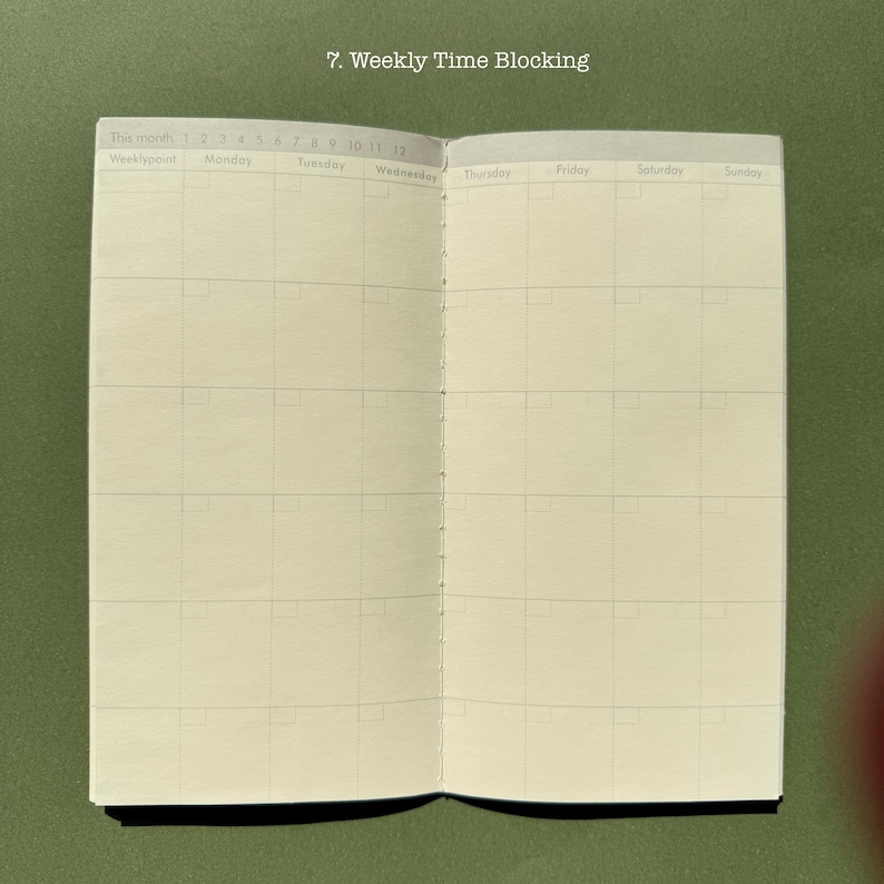 May include: An open planner with cream-colored pages featuring a weekly time blocking layout. The header reads 7. Weekly Time Blocking, followed by columns for Monday through Sunday and a numbered month section from 1 to 12.