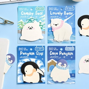 May include: Four sets of animal-shaped sticky notes on blue backing cards. The designs include a white seal labelled Chubby Seal, a white bear with a pink scarf labelled Lovely Bear, a black and white penguin labelled Penguin Qiqi, and a penguin with a blue scarf labelled Cute Penguin. Each card contains 30 sheets.