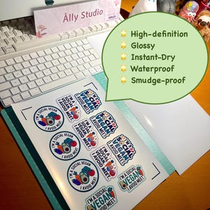 May include: A sheet of glossy, waterproof, and smudge-proof stickers featuring the text I'M A SOCIAL VEGAN I AVOID MEAT. The stickers include colorful illustrations of an avocado, carrot, and tomato, arranged in circular and rectangular shapes.
