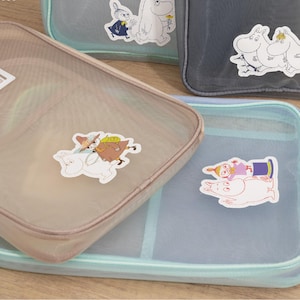 May include: A white ceramic mug with a black handle and the text "But First, Coffee" in a black, bold font. The mug is sitting on a wooden surface. The mug is 4 inches tall.