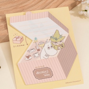 May include: A yellow notepad with a pink and brown striped design. The notepad features illustrations of Moomin characters and the text "Moomin's Letters". The notepad has a gift box illustration and text in Chinese.