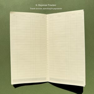May include: An open expense tracker notebook with off-white pages featuring printed grids for tracking income, spending, and payments. The text 9. Expense Tracker and Track income, spending & payments is printed at the top of the page.