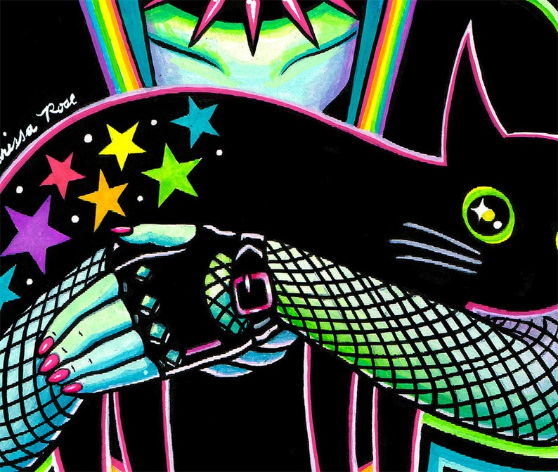 May include: A black cat with green eyes and a white star on its forehead is being held by a person wearing a black fishnet glove with a silver buckle. The person's arm is adorned with colorful stars.