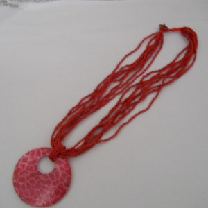 Red Beaded necklace with red/white plastic pendant